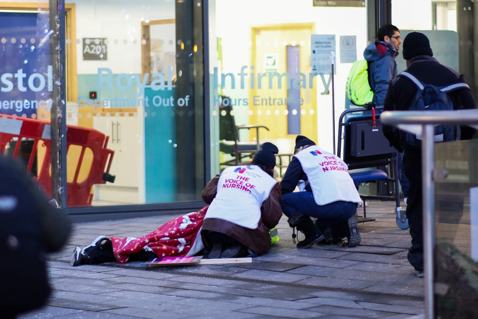 Striking nurses break picket line to help man who had collapsed