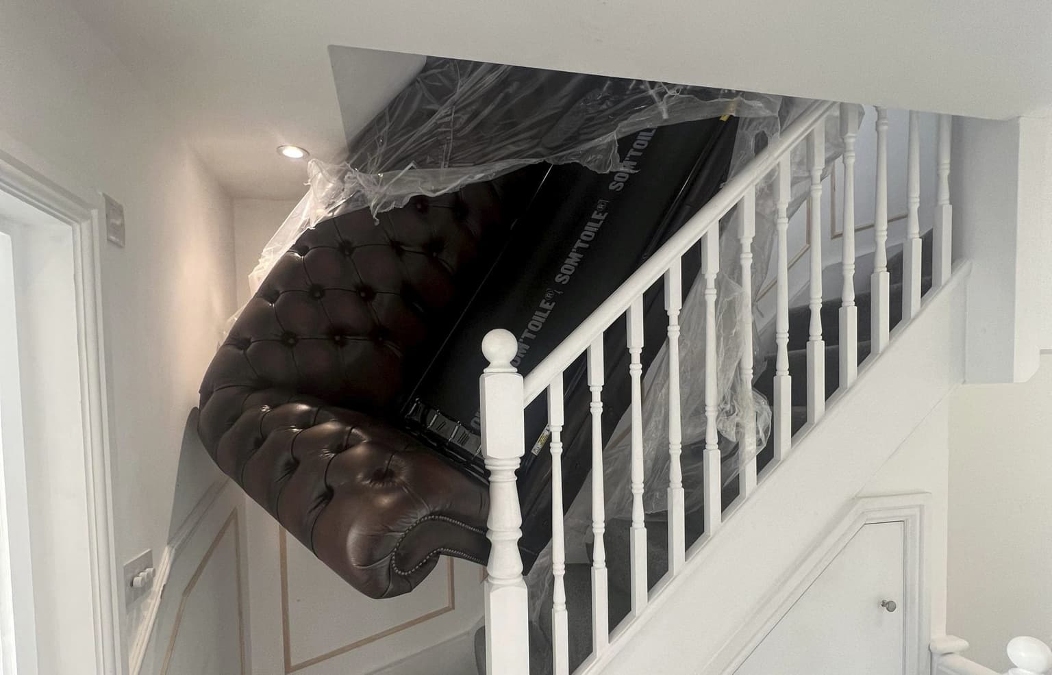Homeowners furious after delivery men leave brand new sofa wedged in staircase