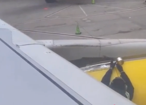 Passenger spots employee putting tape on the wing of a plane before takeoff